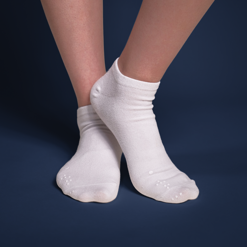 Front view of a model wearing Matchables white ankle socks, showing the comfortable fit and subtle placement of the tactile markers.